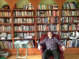Andy in front of his personal library.